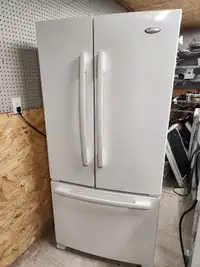 White fridge with French doors on top and freezer on the bottom 