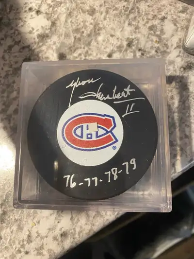 this is a rare autograph puck of the Montreal Canadiens Yvon Lambert has a COA from Frozen Pond coll...