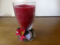 Red Christmas candle in a glass with flower design