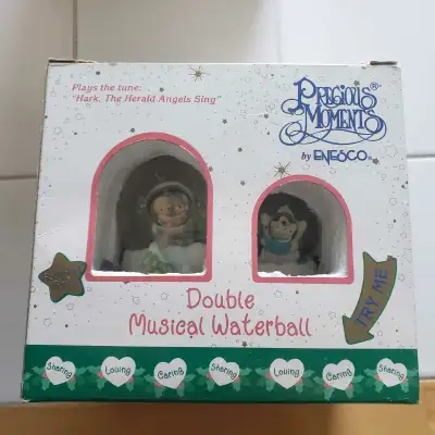 This Precious Moments double musical waterball by Enesco plays "Hark, The Herald Angels Sing" and fe...