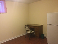 A neat private room in 10 ft deep basement of house near subway