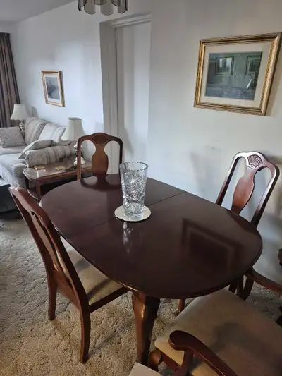 This is made of cherry wood. Four chairs. No marks. One handle on the bottom door is broken on the b...