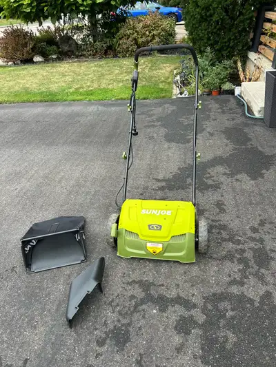 SunJoe electric Lawn Dethatcher with collection bag, cable and accessorie. I got it at Home Depot at...