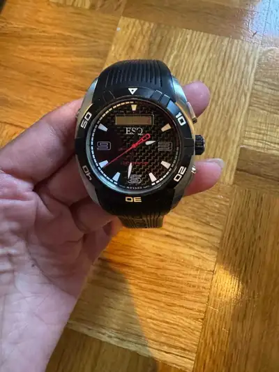 This pre-owned ESQ by Movado Octane chronograph watch features a bold carbon fiber dial with a relia...