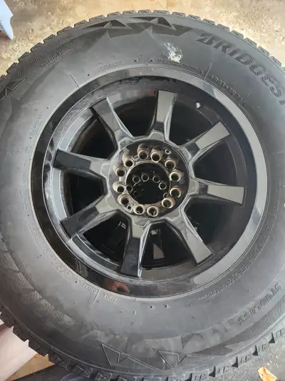 Winter tires on rims Excellent condition Very little use Set of 4 with caps Bridgestone P26570R17 $1...