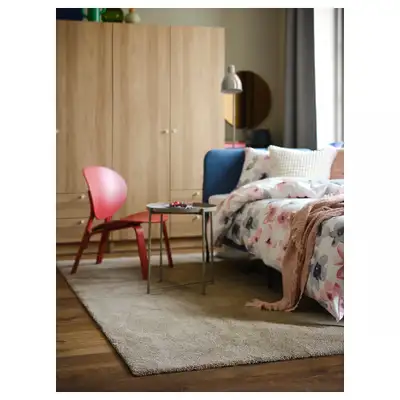 This is a beige IKEA rug, sized at 5x7 feet, perfect for adding a touch of warmth and comfort to any...