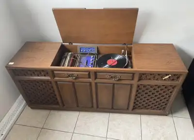 Step back in time with this vintage record player console! It's a blast from the past with a few bum...