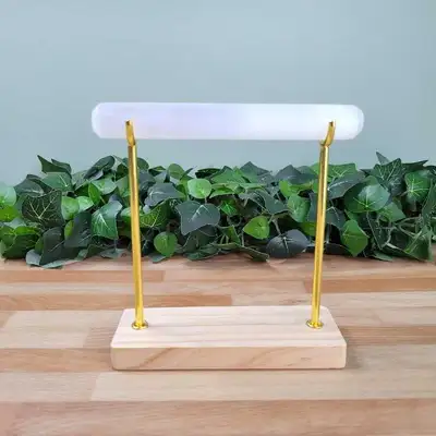 This brand new bracelet holder features a sleek 6-inch selenite wand supported by elegant gold-toned...