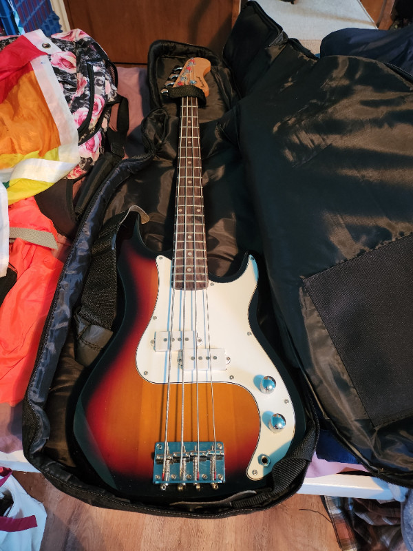 Electric Bass Guitar with carry case, auto tuner and books in Guitars in Belleville