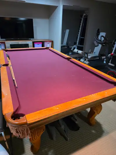 Full size pool table for sale. Measures 56''x103''. Comes with snooker and standard balls, 2 cues, c...