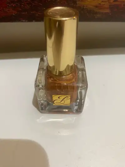 Gold-toned shimmer nail polish. Brand new and unopened.