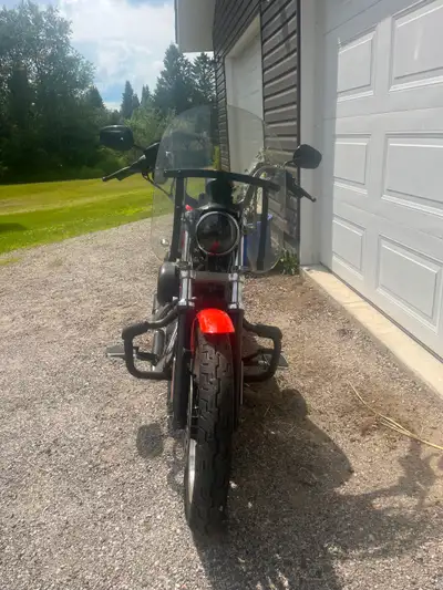 Very Clean 2006 Harley-Davidson Sportster 883R in orange with a black leather seat. This motorcycle...