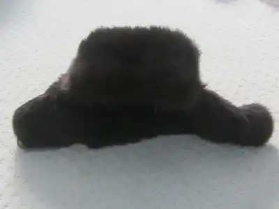 This dark brown old fashioned fur trapper hat is quite unique. It does appear to be a small size. Th...