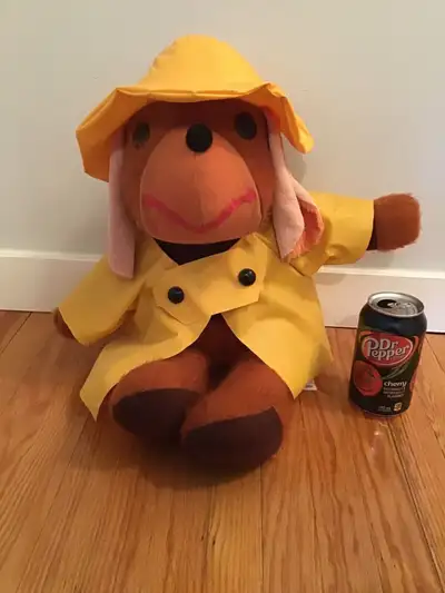 Adorable stuffed dog in a yellow vinyl raincoat and hat. Made by Ganz Bros. About 21” from top of ha...
