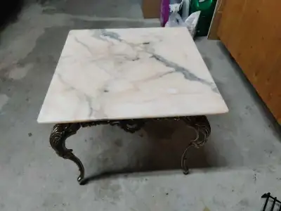 This solid marvelous marble end table features a square marble top and ornate metal legs, making it...
