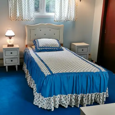 Complete white bedroom set including: single bed, headboard, legged box spring, mattress, bedding, 2...
