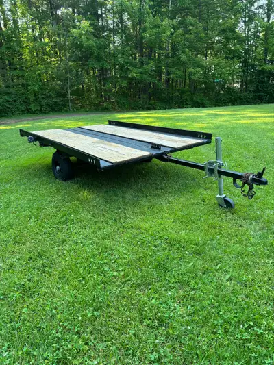 Utility flat bed tilting trailer. In good solid condition. 8ft long by 5.5 ft. 1 7/8 ball. Lights wi...