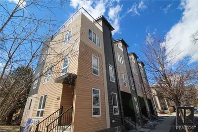 Main floor open space with bathroom and wet bar. Second floor is the kitchen with island and living...