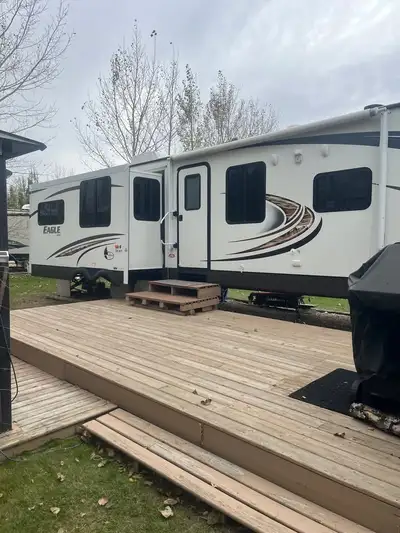 Everything Works "WELL MAINTAINED": 2013 Triple Slide Eagle Travel Trailer, Features a spacious rear...