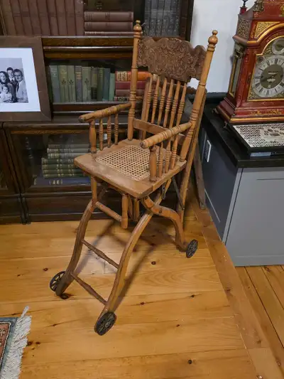 Beautiful antique wooden high chair. Converts into a stroller/walker. Has lovely carved detail on th...