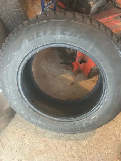 Offering a set of four Bridgestone Blizzak winter tires, size 225/65R17, perfect for providing super...