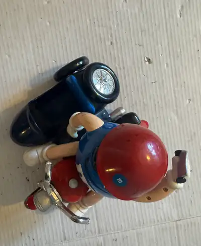 I'm offering an M&M figurine riding a motorcycle with a sidecar, perfect for collectors or as a fun...