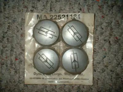 oldsmobile plastic center caps,from the sixties or seventies,still in original packaging,not sure if...