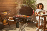 A brand new coleman road trip grill is for sale.