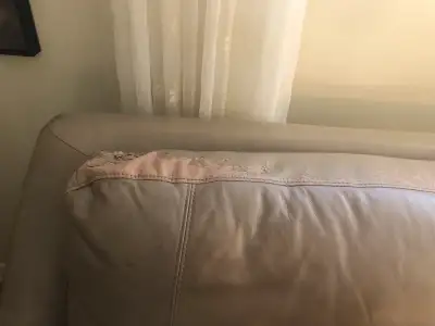 Leather taupe couch with some leather match. Leather match is peeling as per pictures. Couch is very...