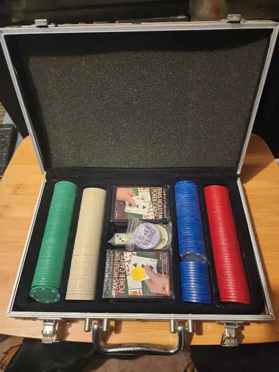 This poker set comes complete with chips, cards, and dice, all neatly arranged in a sturdy aluminum...