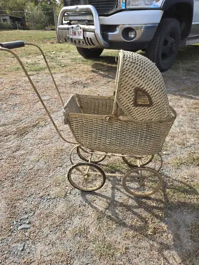 Step back in time with this charming vintage wicker pram, perfect for collectors or as a unique deco...