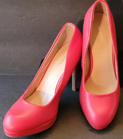 Make a statement in these red leather high heel shoes from Le Chateau. Preowned but in like new cond...