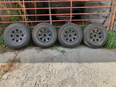 Set of 4 Truck snow tires on black GM steel rims. These tires are 265 /70R 17 115R Bridgestone Blizz...