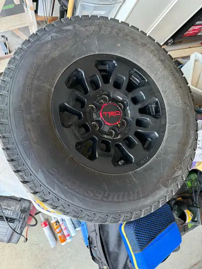 Set of four (4) authentic Toyota Tacoma TRD Pro wheels wrapped in almost new Bridgestone Blizzak DM-...