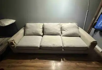 A well used couch with torn arm rests from dogs. Pick up from St. Norbert.
