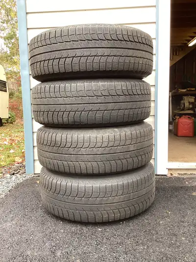 Four Michelin X ice tires 265/70 R17 on universal aluminum rims (2 sets of bolt holes). Dodge Ram &...