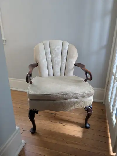 Beautiful antique armchair with carved wood arms and cabriole legs, likely dating to the early 20th...
