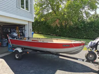 Red and silver 14ft aluminum boat for sale, asking $2500. Comes with working outboard motor, trollin...