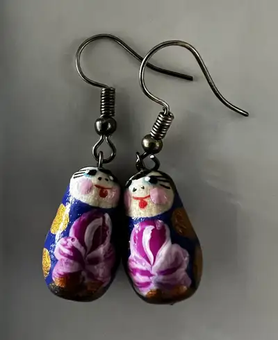 Cute pair of matryoshka doll earrings! They have a fun, whimsical design with a blue and gold colour...