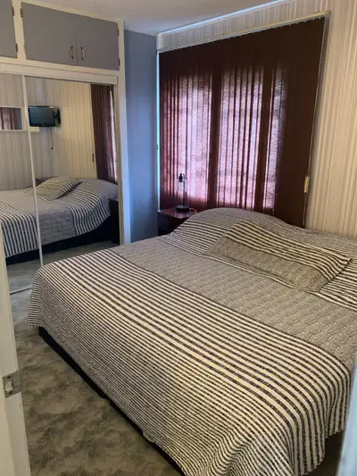 A cozy 4 bedroom in a 3 level house with one full bath room in the main floor and a toilet and showe...