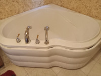 corner bathtub , comes with taps in good condition