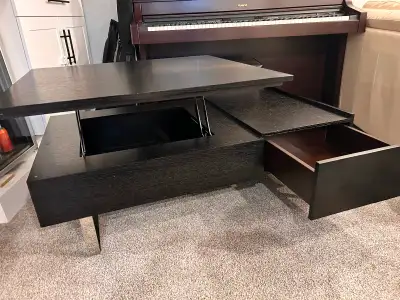 One side of the tabletop lifts to a height of 62cm (24.5in) for working or dining. Underneath the re...