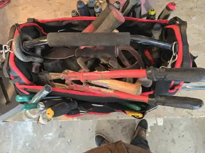 This mechanic's tool bag comes equipped with an array of tools, perfect for various tasks, though th...