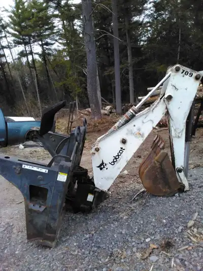 Bobcat skidsteer front mount backhoe. Works perfect no leaks. Teeth good. Comes wth bucket. All hydr...