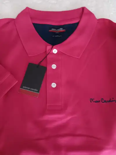 POLO GOLF SHIRT NEW PIERRE CARDIN DESIGNER WEAR. CORAL COLOUR, SIZE XXL. NEVER WORN. ASKING $25.00....