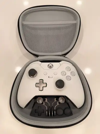 Premium white Xbox One Elite controller. Has original carrying case and all the accessories like dif...