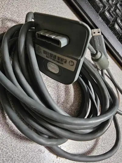 This is a grey Microsoft Xbox 360 controller cable, in used condition. It's perfect for connecting y...