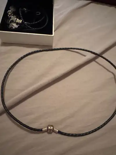 This is a used Pandora braided black leather necklace, perfect for showcasing your favourite charms...