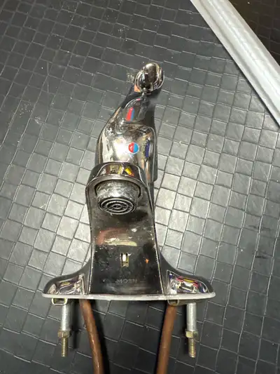 This is a Moen bathroom faucet, perfect for any sink setup. It's in used condition, showing some sig...