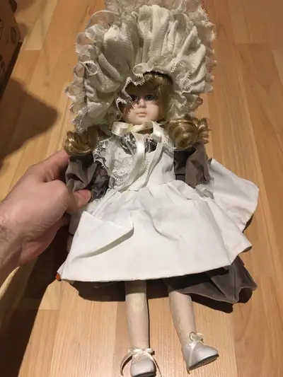 The legs and hands feel porcelain the head is some other strong material The doll has a musical box...